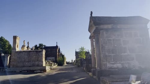 Old historical cemetery with large stone graves and small chapels and old tombstones without people