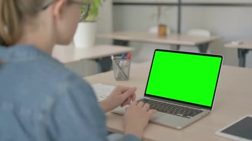 Young Woman Working on Laptop with Green Chroma Screen