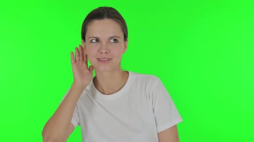 Young Woman Trying to Listen on Green Background