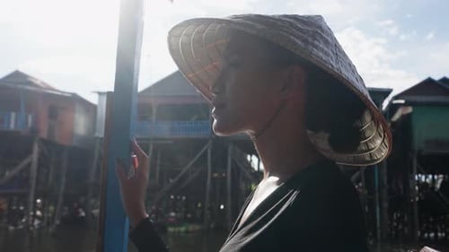 A Closeup Of A Woman In A Floating Village