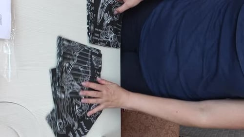 A Woman Reviews Cloth Napkins. Lay Out And View From Different Angles. Vertical Video.