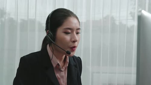 Woman Working at Computer with Headset