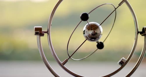 Kinetic Mobile Featuring Shiny Metal Ball and Rings