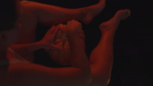 Adults Carve Halloween Pumpkin in Dark Home at Night