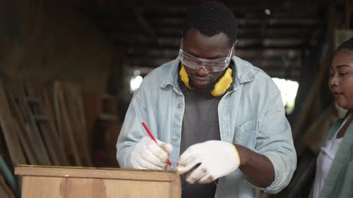 Carpenter make furniture at workshop.