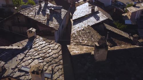 Establishing drone shot of a small town on the italian alps, aerial view on a sunny day