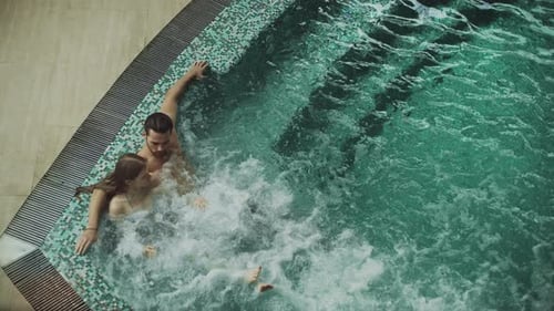 Romantic Couple Relaxing at Whirlpool Bath Together. Beautiful Couple Enjoying Relax In