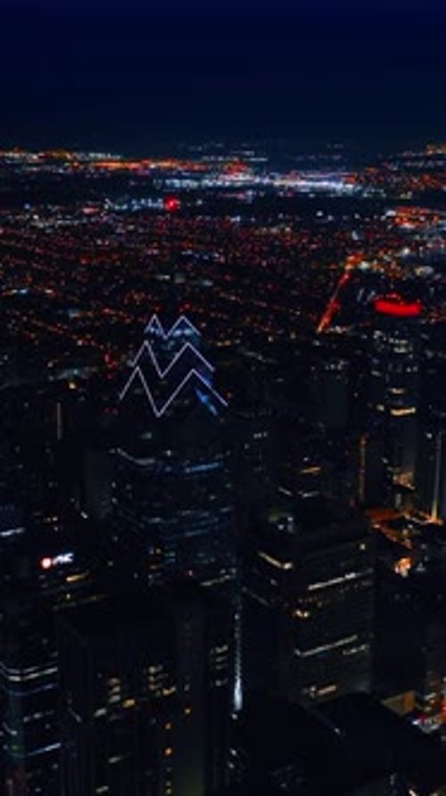 Flying above the vast scenery of luminous lively city at night. Breath-taking view of Philadelphia