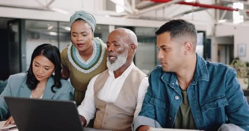 Diverse Team Collaborating on Laptop in Modern Office