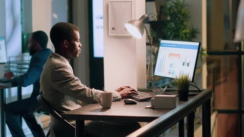 Young Adult Working at Desk in Modern Office