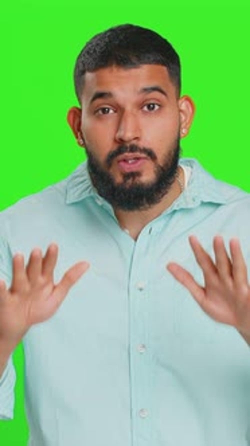 Young Adult Man Gesturing and Talking on Green Screen