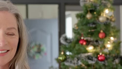 Woman Smiling near Christmas Tree at Home