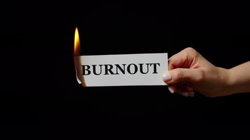 The Word Burnout on Burning Card held in Hand
