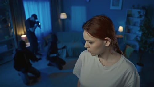 Intrusion: Woman and Masked Burglars in a Dark Room