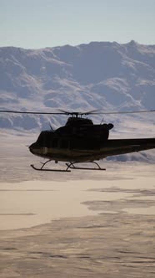 Helicopter Flying Over Mountain Range