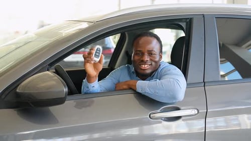 Happy African American Man Showing the Key of His New Car