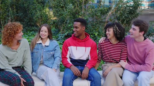 Five Young Adults Talking Together Outside