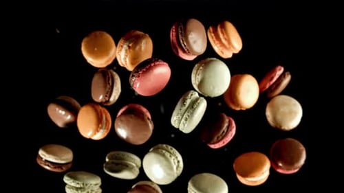 Colorful Macarons Floating Against a Black Background