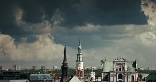 old town square city hall tower dramatic storm clouds Poznan cityscape - timelapse