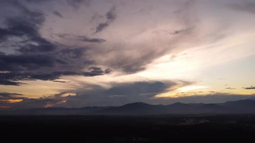 Aerial view of beautiful sky with clouds and sunlight during sunset.