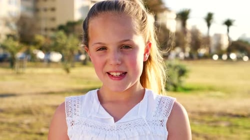 Girl child, park and smile on face in sunshine, nature and outdoor for play, holiday and happiness