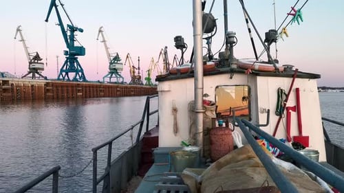 Boat sails at industrial seashore
