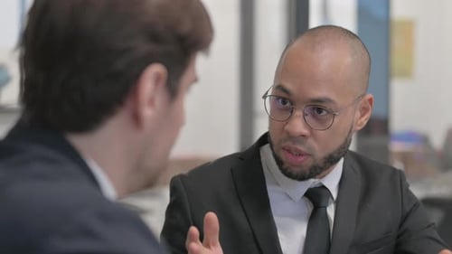Close up of Angry Mixed Race Businessman in Argument