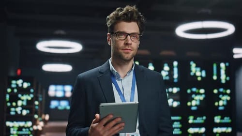 Smiling Man Holding Tablet in Modern Tech Office