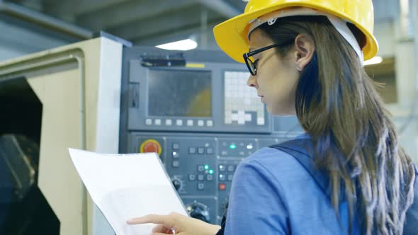 Professional Female Operator in Hard Hat Setting up/ Programming CNC ...