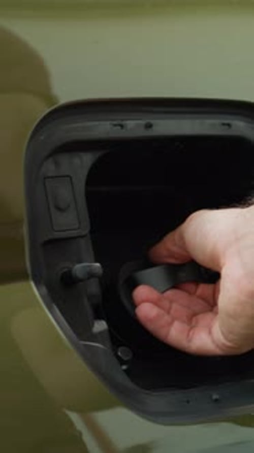 Vertical Video Close Up of Driver Opening EV Car Charging Port Flap to Charge Battery