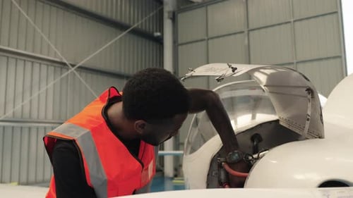 Aircraft Maintenance Engineer Inspecting Plane Engine in Slow Motion