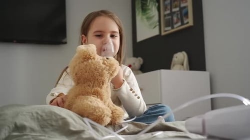 Girl Uses Nebulizer While Playing with Toy Dog