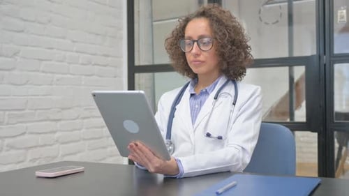 Female Doctor Working With Tablet in Office