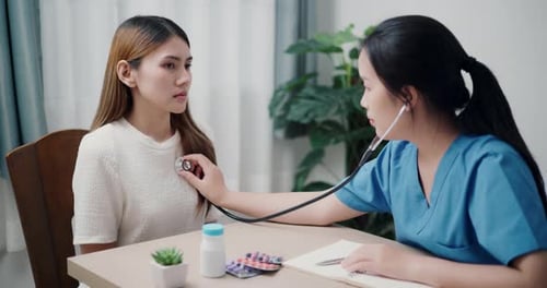 Doctor Listens to Patient's Heart with Stethoscope