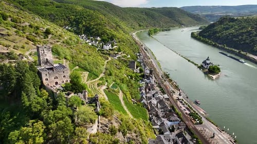 Aerial footage over the Rhine Valley with medieval hillside castle Gutenfels, vineyards, town of Kau