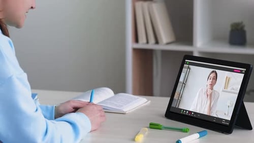 Woman Attends Online Meeting on Tablet at Home