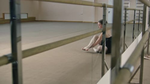Young Woman Stretching in Bright Dance Studio
