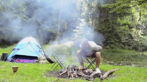 Teenage Boys Camping at the Lake in Forest