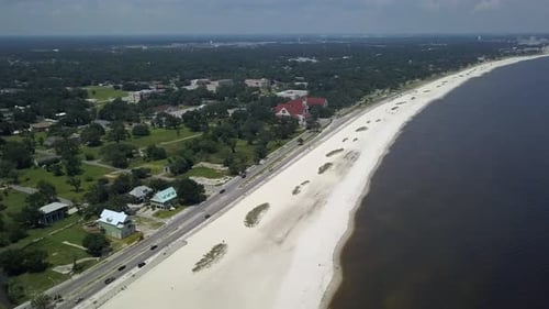Truck driving off in the distance off the shore in Long Beach, Mississippi.