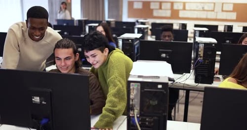 Young Multiracial Students Learning Together Inside Computer Classroom at School Academic