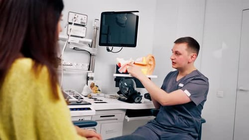 an ENT doctor consults a patient in the clinic's office tells about the possible consequences