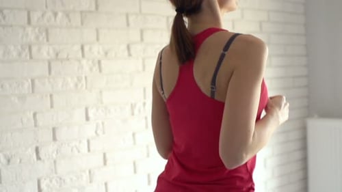 Woman Doing High Knees Exercise Indoors in Sportswear