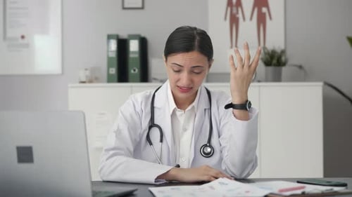 Stressed Woman Doctor Exhausted in Office Setting