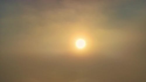 Golden Sun Rising Above Rolling Clouds Aerial View