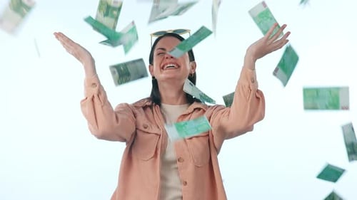 Happy woman, money rain and celebration in winning, lottery or finance savings against a studio