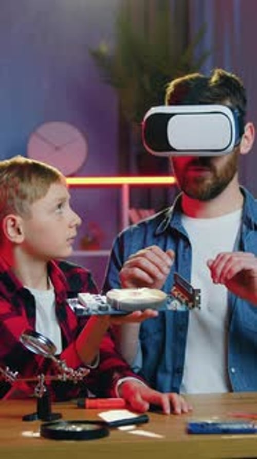 Father and Son Explore Motherboard with VR Headset
