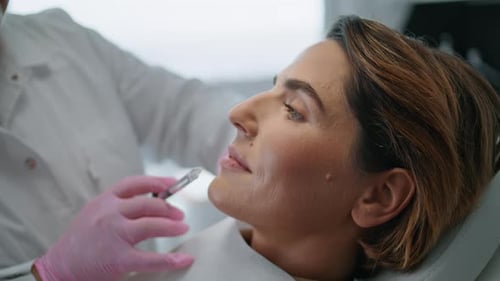 Woman Making Botulinum Therapy in Modern Cosmetology Clinic Close Up. Professional Cosmetologist
