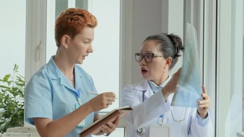 Medical Professionals Analyzing X-Ray in Modern Office