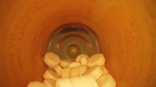 Pills Falling from a Pill Bottle