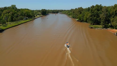 Following a Motorboat on the Brown River Aerial View
